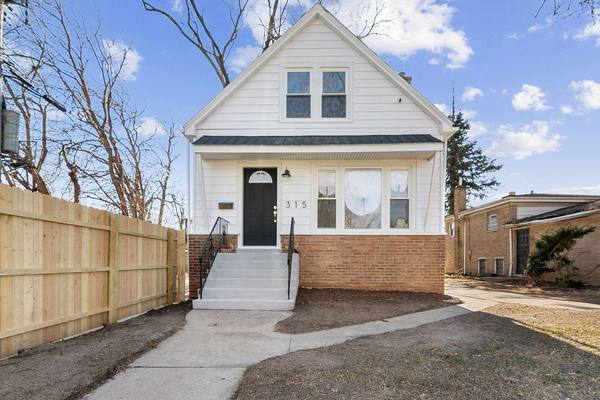 Restored workers cottage, frame over a brick base. The housing stock in South Chicago and the East Side is mostly frame workers cottages.