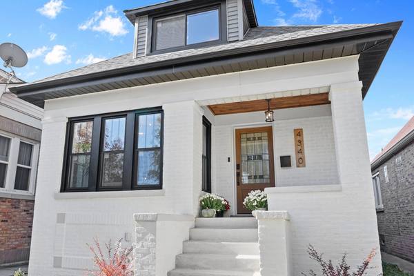 Restored Chicago brick bungalow, hipped roof and raised entry. The housing stock in Auburn Gresham is mostly brick bungalows.