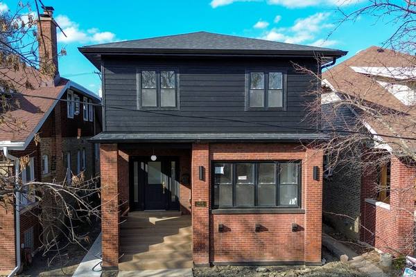 Rear brick elevation of a two-flat. The housing stock in West Englewood is mostly brick two-flats.