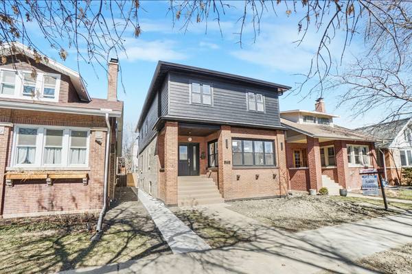 Brick front elevation and entry on a bungalow block. The housing stock in Chicago Lawn and Marquette Park is mostly brick bungalows.