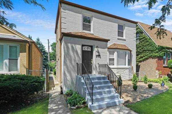 Restored brick two-flat, bay window and limestone base. The housing stock in Englewood is mostly brick two-flats.