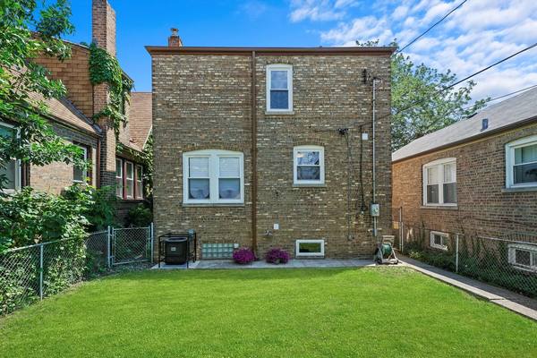 Rear masonry elevation and yard, finished. The housing stock in Woodlawn and Washington Park is mostly brick two-flats.